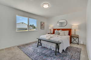 Carpeted bedroom featuring baseboards