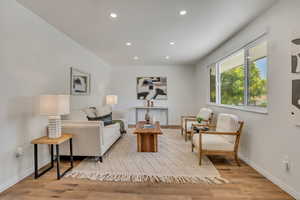 Living room with recessed lighting and wood finished floors