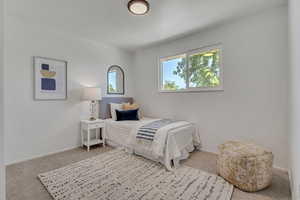 Bedroom with carpet floors and baseboards