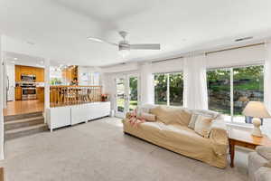 Living room featuring ceiling fan, a chandelier, recessed lighting, and light colored carpet