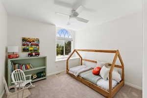 Carpeted bedroom with baseboards and ceiling fan