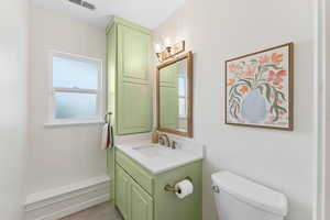 Half bath featuring vanity and tile patterned flooring