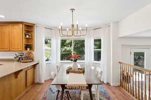 Dining room with a chandelier and light wood-type flooring