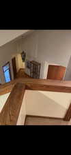 Stairway featuring lofted ceiling