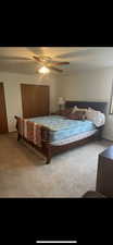 Carpeted bedroom featuring ceiling fan