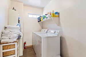 Laundry room featuring independent washer and dryer and baseboards