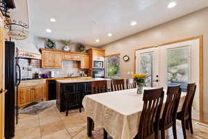Dining room featuring recessed lighting, french doors, and light tile patterned floors