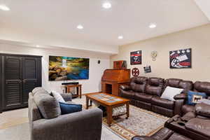 Living area featuring light carpet and recessed lighting