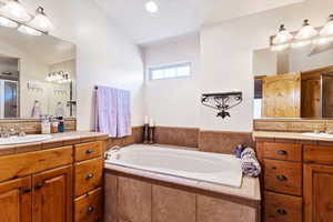 Full bath featuring two vanities and a garden tub