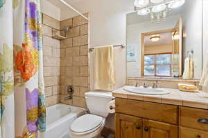 Full bath featuring vanity and shower / tub combo