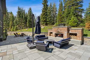 View of patio with an outdoor living space with a fire pit