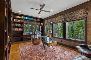 Office space with ceiling fan, plenty of natural light, wood finished floors, and recessed lighting