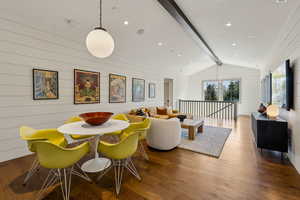Dining area featuring wood finished floors, wooden walls, and recessed lighting