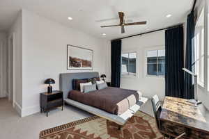 Carpeted bedroom with recessed lighting and ceiling fan
