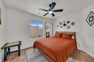 Tiled bedroom featuring baseboards and ceiling fan