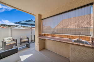 Fenced backyard with area for grilling and a patio area