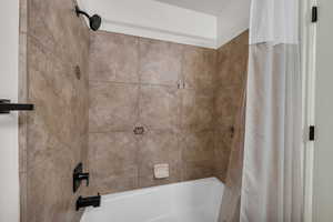Bathroom featuring shower / bath combination with curtain