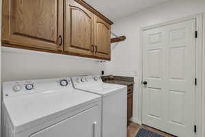 Washroom with washer and dryer and cabinet space