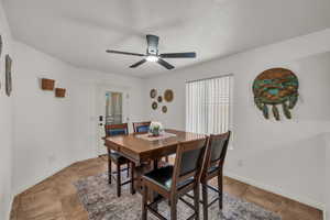 Dining space with a ceiling fan and light tile patterned floors