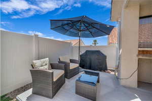 Fenced backyard featuring a grill, a patio area, and outdoor lounge area