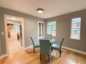 Dining space featuring light wood-type flooring and baseboards