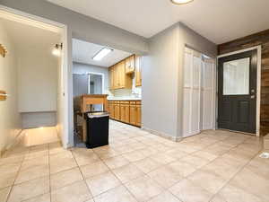 Kitchen with light tile patterned flooring and light countertops