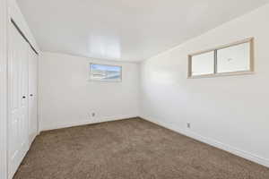 Unfurnished bedroom featuring a closet and carpet flooring
