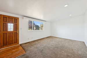 Foyer entrance featuring carpet floors and recessed lighting