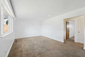 Carpeted spare room featuring baseboards and recessed lighting