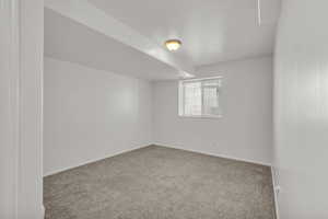 Carpeted spare room with baseboards