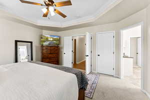 Bedroom with crown molding, light colored carpet, and ceiling fan