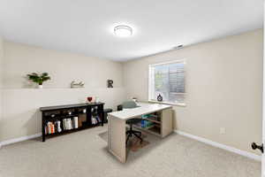 Home office with light colored carpet