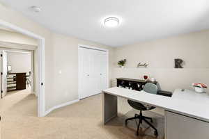 Office space featuring light carpet and baseboards