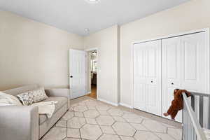 Sitting room with light colored carpet and baseboards