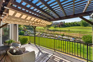 Deck featuring a fenced backyard and a pergola