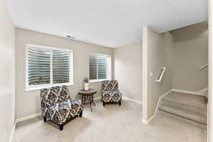 Living area featuring carpet floors and stairway