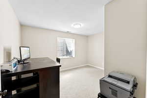 Office area with baseboards and carpet flooring