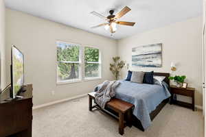 Bedroom featuring light colored carpet and ceiling fan