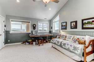Bedroom with vaulted ceiling, wainscoting, carpet floors, ceiling fan, and recessed lighting