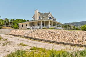 View of front of property with a porch and a chimney