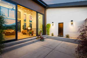 Property entrance featuring a patio area and outdoor lounge area
