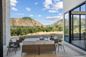 View of patio with a mountain view and outdoor lounge area