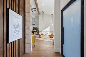 Entrance foyer with hardwood / wood-style floors, a ceiling fan, and beamed ceiling