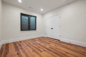 Unfurnished bedroom featuring wood finished floors and recessed lighting