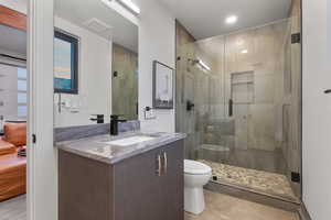 Full bathroom with vanity, tile patterned floors, a stall shower, and recessed lighting