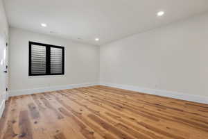 Spare room featuring light wood-style floors and recessed lighting