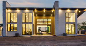 Back of house with an outdoor living space