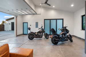 Garage featuring electric panel, recessed lighting, and ceiling fan