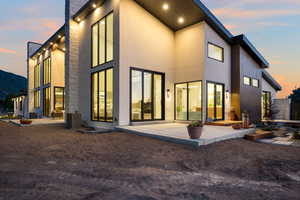 Rear view of house with a patio and stucco siding