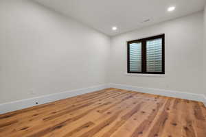 Empty room featuring wood finished floors and recessed lighting